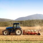 Agriculture plowing tractor on wheat cereal fields working