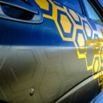 Pasting Of Car With Carbonic Vinyl Wrap Closeup