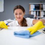 Professional cleaners working in a business environment, showing the importance of workplace cleanliness and maintenance.